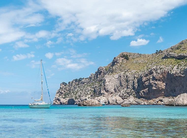 Vista al mar amb un veler solitari i penya-segats