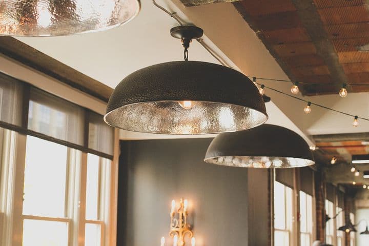 View into a rustic restaurant with industrial-style lamps