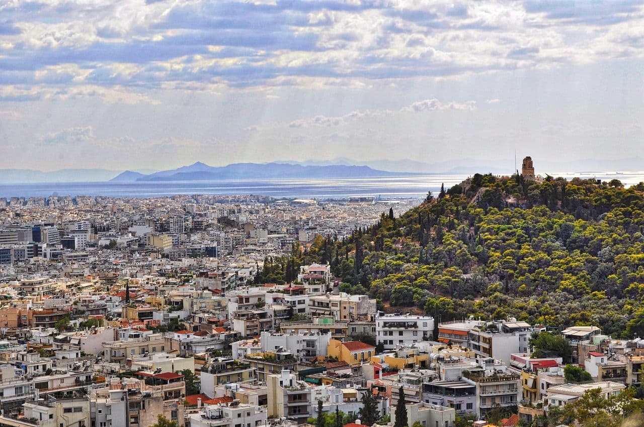 Athens city from drone shot with sun and clouds