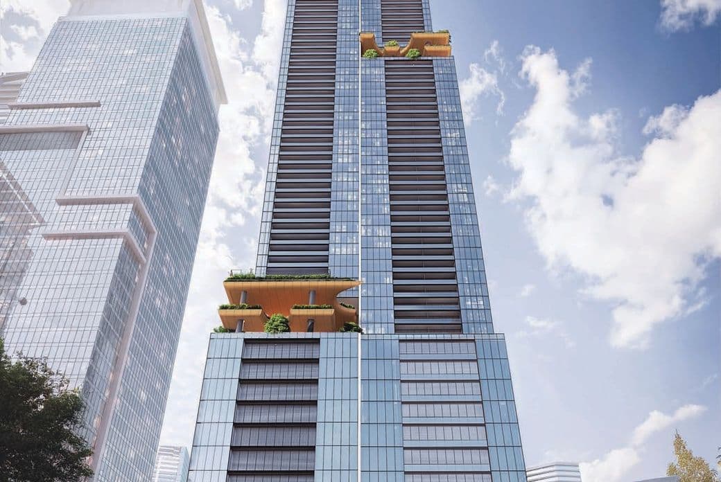 Tall skyscraper with glass facade, featuring golden balconies with greenery. Nearby modern buildings and a clear blue sky.