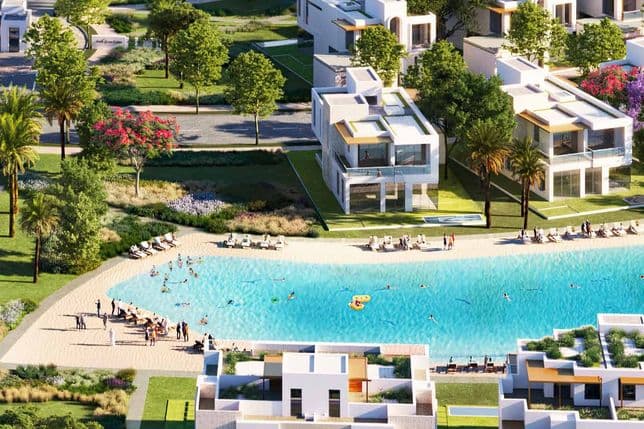 Community view of Hayat Residences with villas surrounding a lake, fountains, lush greenery, and landscaped open spaces.