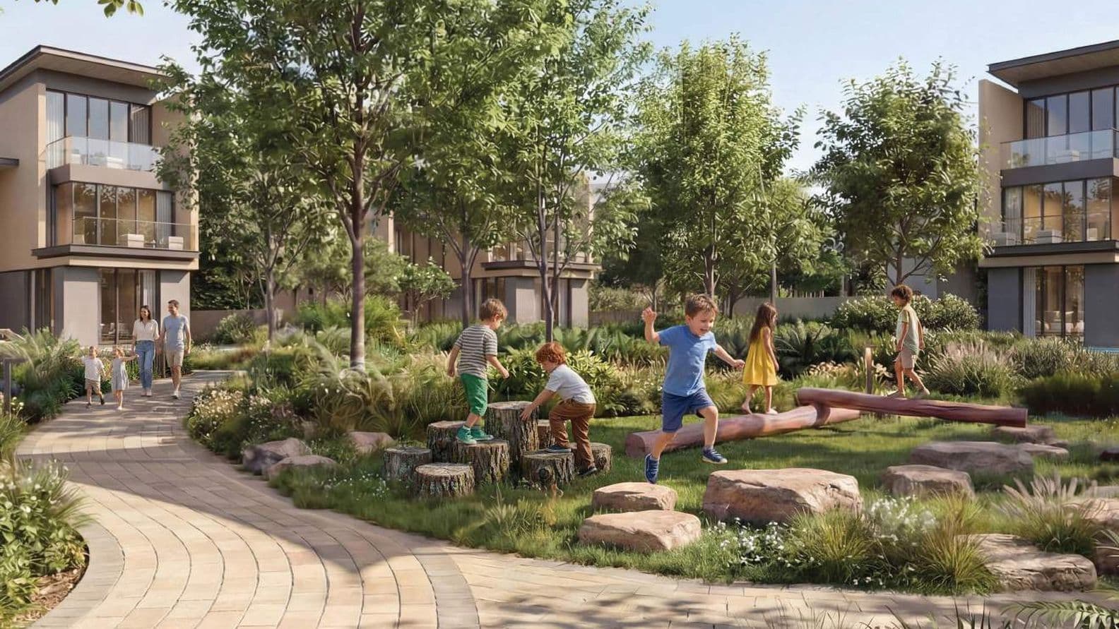 Children play on logs and rocks in a lush garden surrounded by modern houses, while a family walks along a curved brick path.