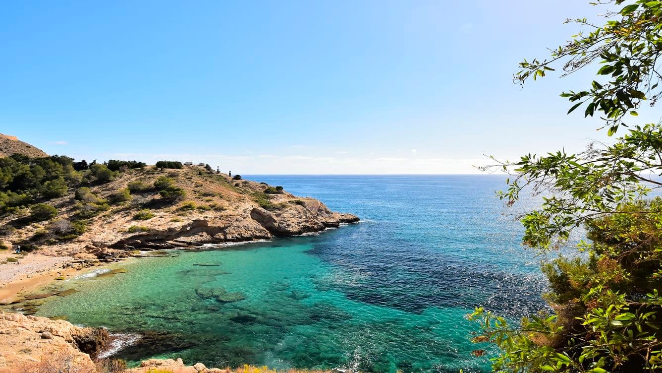 Almadraba Cove in the Rincón de Loix. Rocks, trees, and crystal-clear water.
