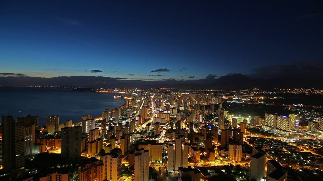 Vistes panoràmiques nocturnes des de la creu de Benidorm. Rascacels, mar a l'esquerra.