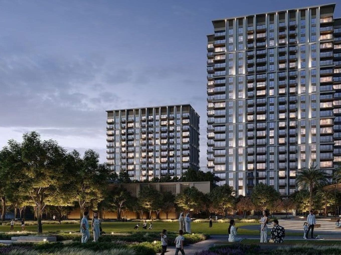 Evening view of residential towers and green spaces at Rosehill Dubai Hills Estate by EMAAR, with families enjoying the landscaped park.