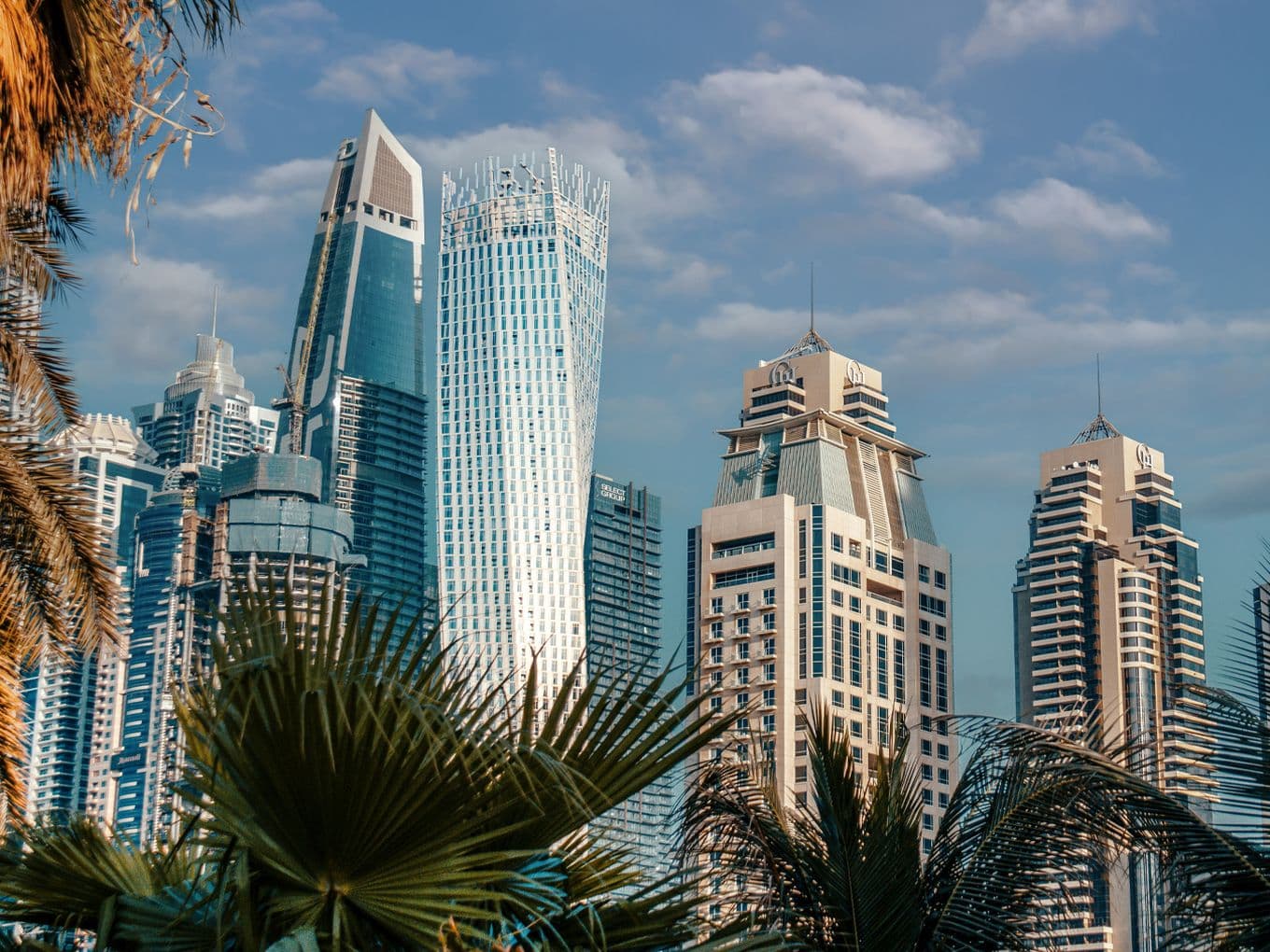 Architectural view of Cayan Tower in Dubai alongside modern high-rises