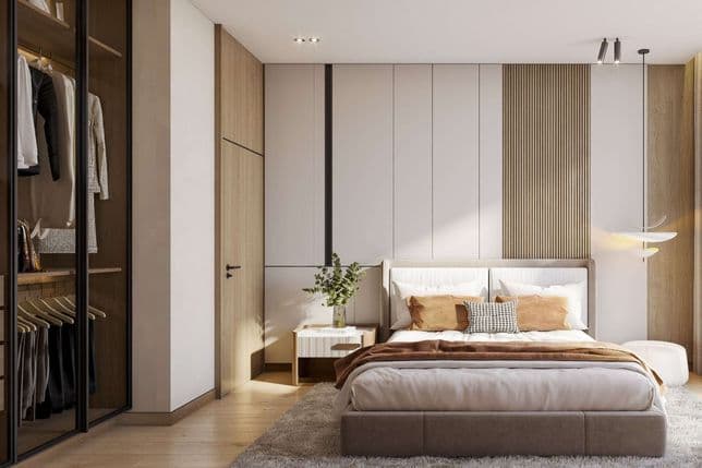 Modern bedroom with a cozy bed, wooden accents, a plush rug, and a glass-door wardrobe. Natural light streams in, highlighting minimalist decor.