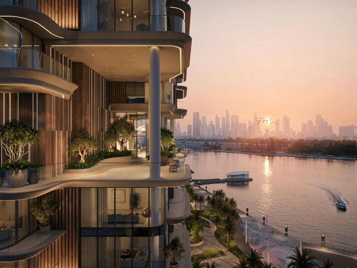 Luxuriöses Apartment am Wasser mit großzügigen Balkonen und Blick auf einen Fluss bei Sonnenuntergang, mit einer entfernten Stadtsilhouette im Hintergrund.