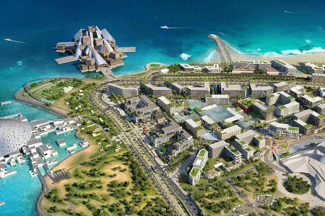 Aerial view of a futuristic coastal city with angular waterfront buildings, lush parks, winding roads, and turquoise ocean. KI-generiertes Bild