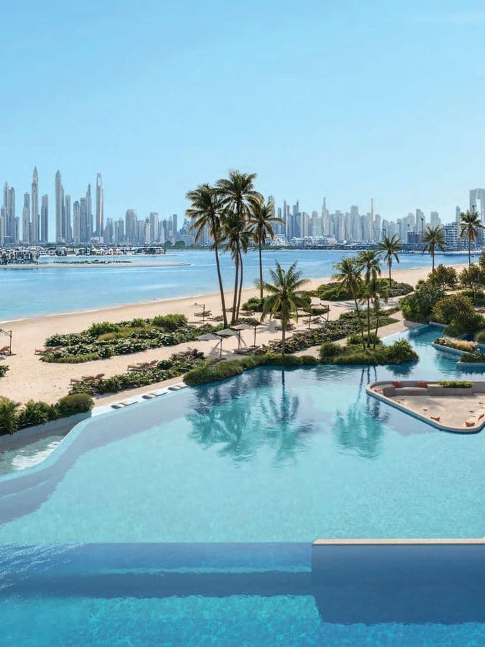 iew from Passo’s pool deck with landscaped pathways, beachfront loungers, and a wide vista of Dubai Marina skyline.