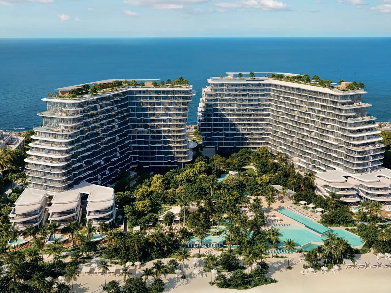 Aerial daytime perspective of Passo by Beyond with two organically shaped towers surrounded by tropical landscaping and beachfront pools.