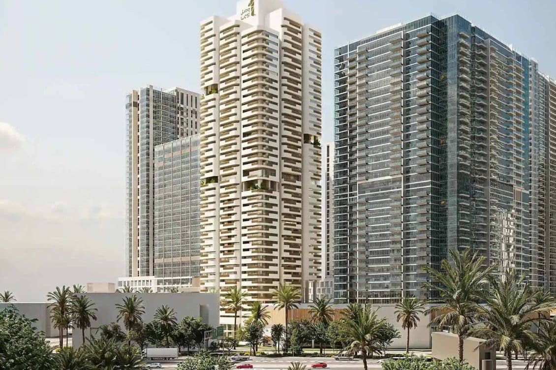 A modern cityscape with tall, glass-clad skyscrapers, surrounded by palm trees and a busy road in the foreground.