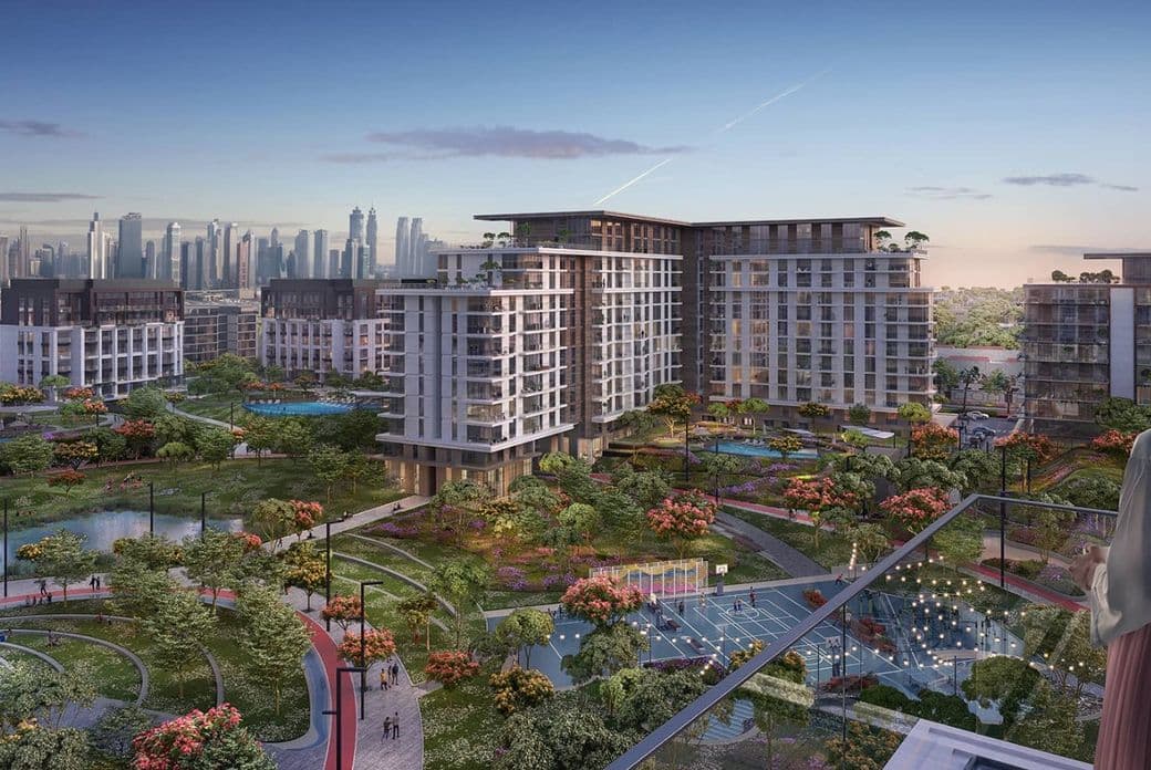 Modern urban development with high-rise buildings, lush green spaces, and water features, set against a city skyline at dusk.