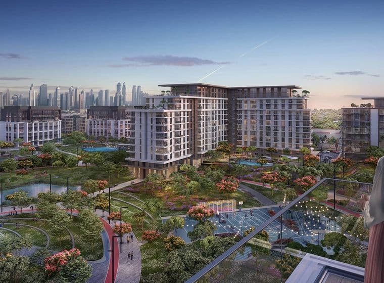 Modern urban development with high-rise buildings, lush green spaces, and water features, set against a city skyline at dusk.