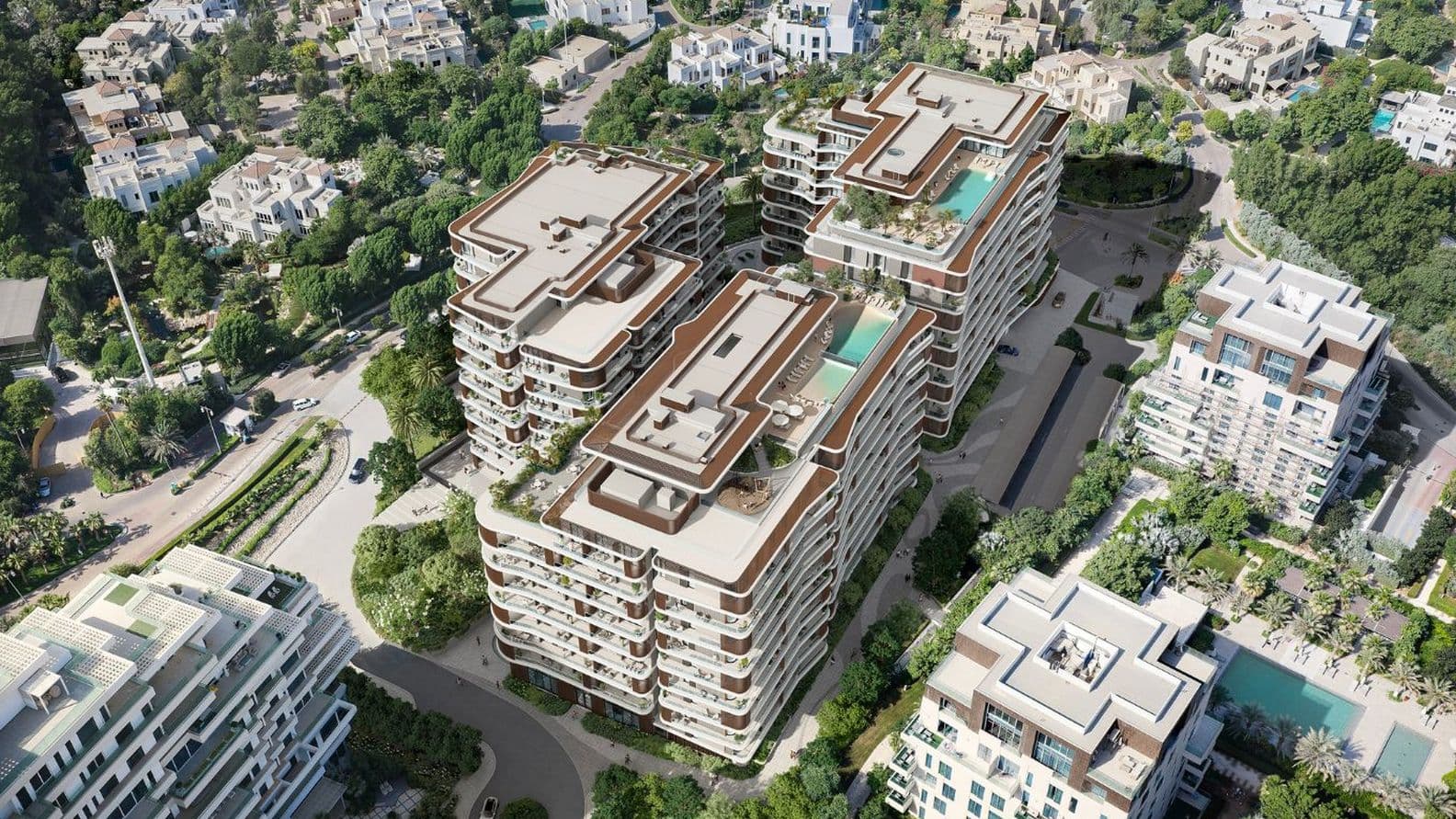 Luftaufnahme moderner Wohngebäude mit Dachpools, umgeben von üppigem Grün und nahegelegenen Straßen.