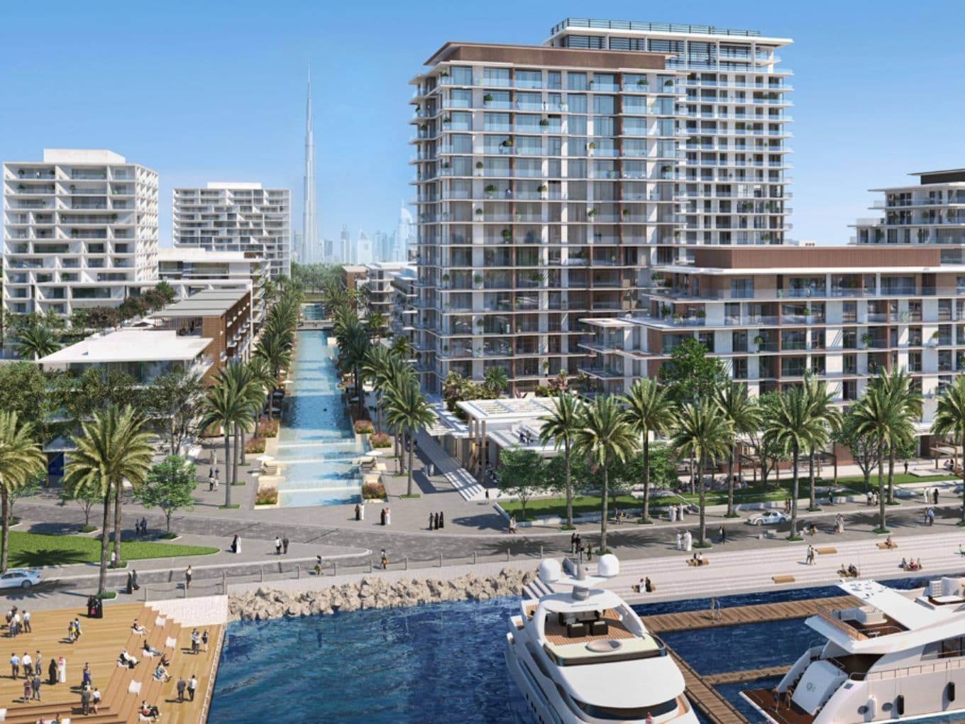 Blick auf die Uferpromenade von Mina Rashid mit Luxusyachten im Vordergrund, palmengesäumten Promenaden, modernen mittelhohen Wohngebäuden und einem zentralen Wasserspiel, das zum Burj Khalifa führt, der in der Ferne in der Skyline sichtbar ist. Fragen Sie ChatGPT