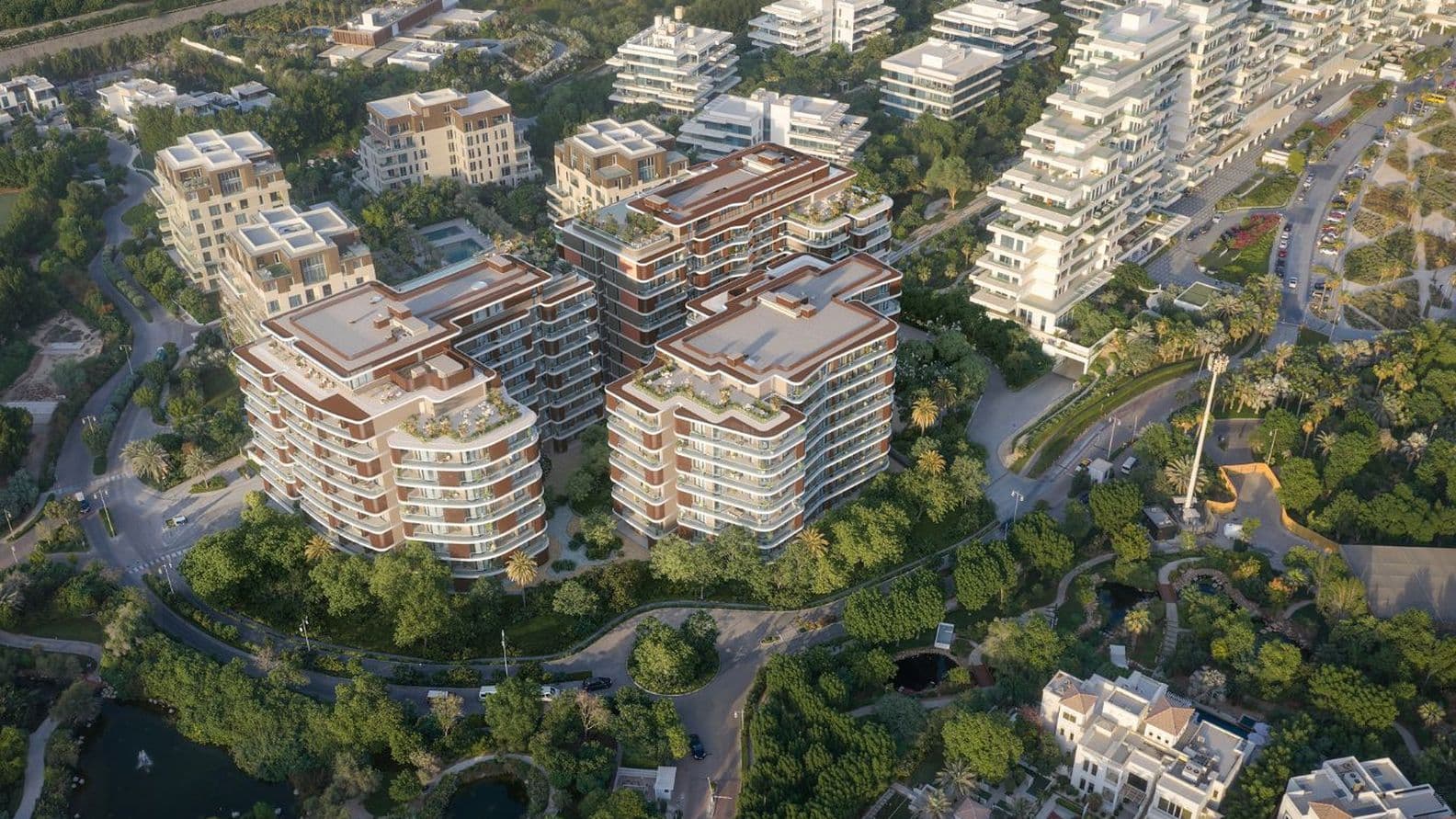 Luftaufnahme eines Wohngebiets mit modernen mehrstöckigen Gebäuden, umgeben von üppigem Grün und gewundenen Straßen.