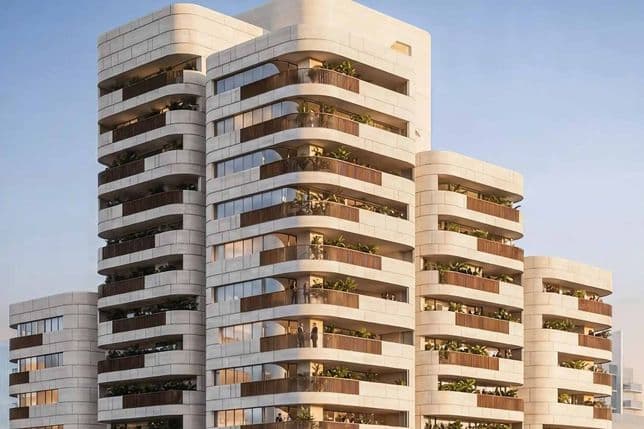Contemporary multi-story building with rounded balconies, glass facades, and greenery on each level under a clear blue sky.