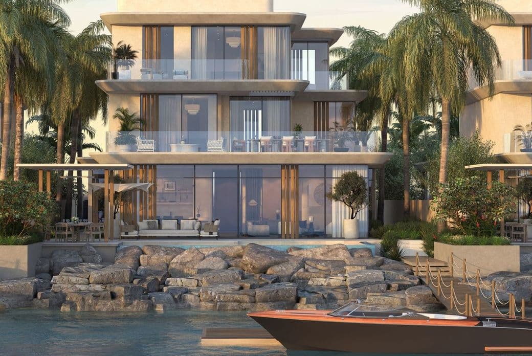 Elegant multi-level villas with private pools and yacht docks on the edge of the Arabian Gulf. Alt Text: Waterfront villas with terraces, palm trees, and a boat dock at Anantara Mina Al Arab.