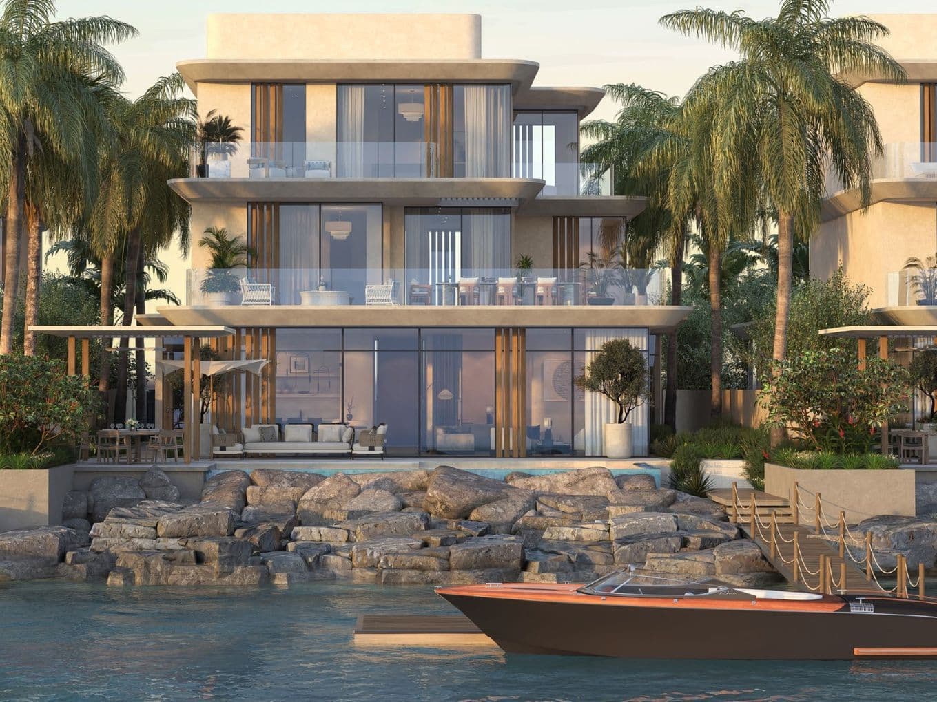 Elegante mehrstöckige Villen mit privaten Pools und Yachtanlegern am Rande des Arabischen Golfs. Alt-Text: Villen am Wasser mit Terrassen, Palmen und einem Bootsanleger bei Anantara Mina Al Arab.