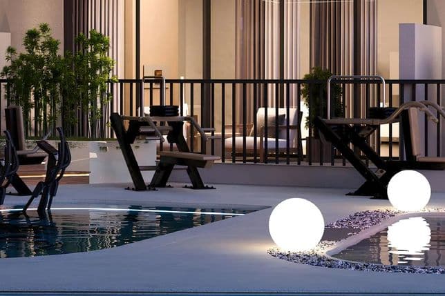 Modern outdoor patio with glowing spherical lights by a pool, surrounded by contemporary furniture and potted plants at dusk.