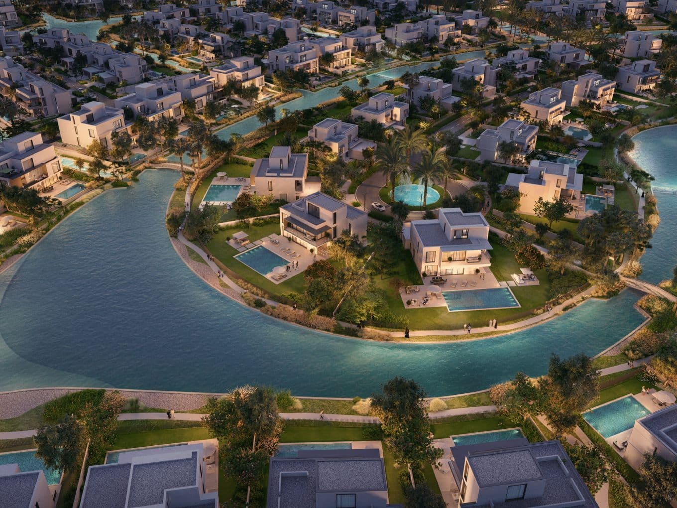 Luftaufnahme von Palmiera Collective im The Oasis by Emaar mit luxuriösen Villen am Wasser, privaten Pools und gewundenen Badelagunen inmitten üppiger Begrünung.