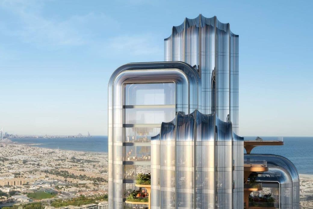 Top view of Lumena tower with ocean and Dubai in the background.