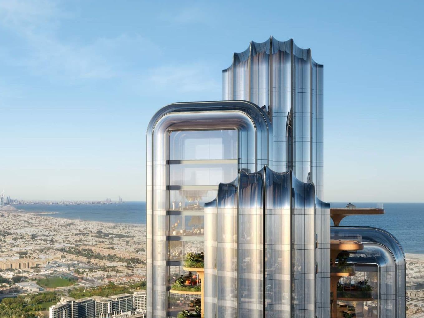 Draufsicht auf den Lumena Tower mit dem Ozean und Dubai im Hintergrund.