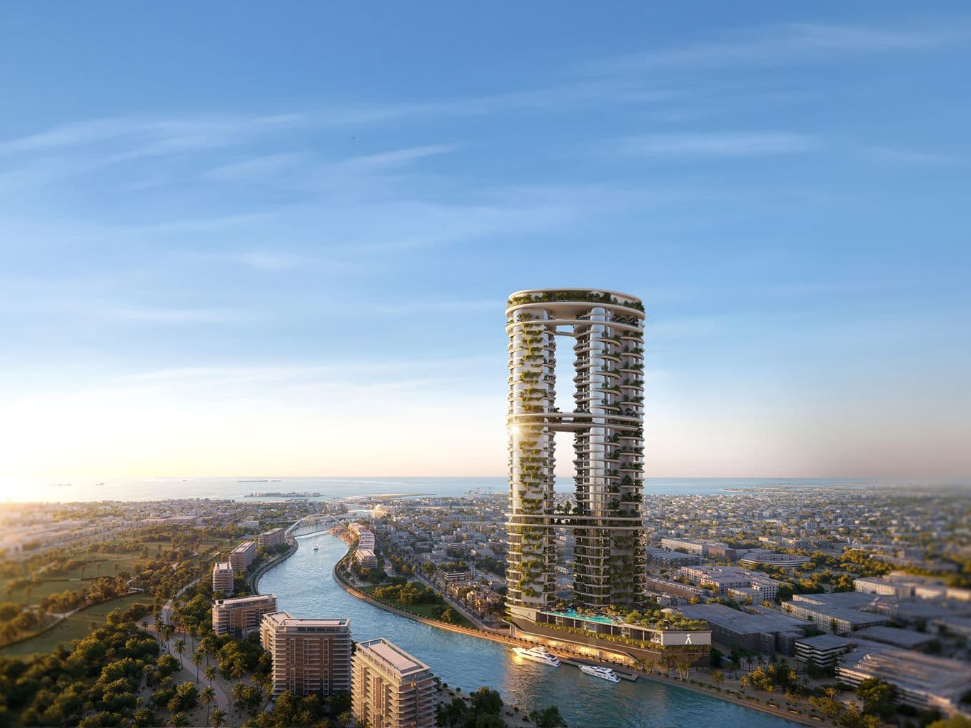 Two circular towers linked by a sky bridge, covered in greenery, rising beside a winding canal with boats and a distant city under a blue sky.