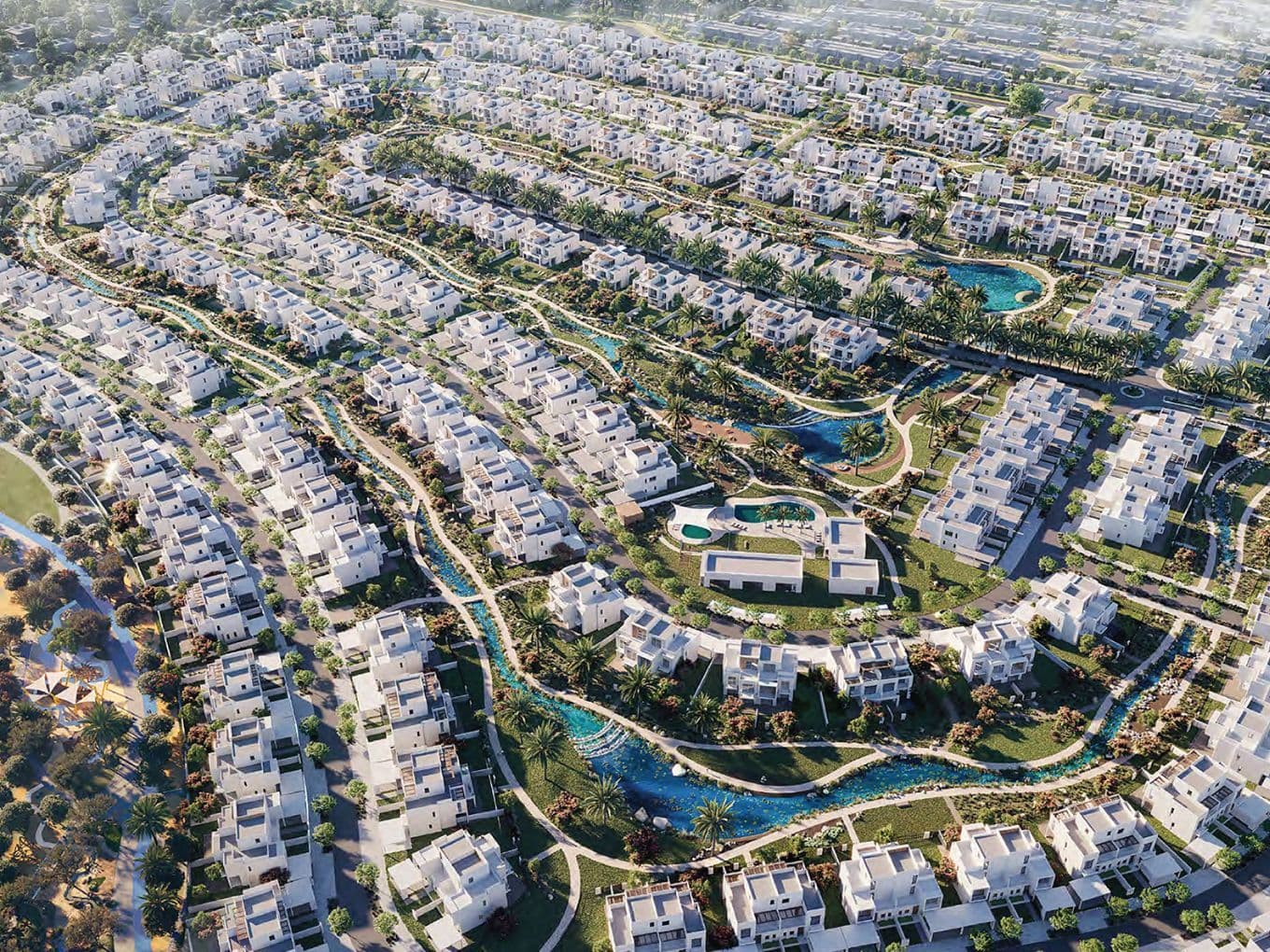 Ein panoramischer Luftblick auf die Community The Valley mit Reihen moderner weißer Villen, üppiger grüner Landschaftsgestaltung, geschwungenen Wasserläufen und miteinander verbundenen Spazierwegen.