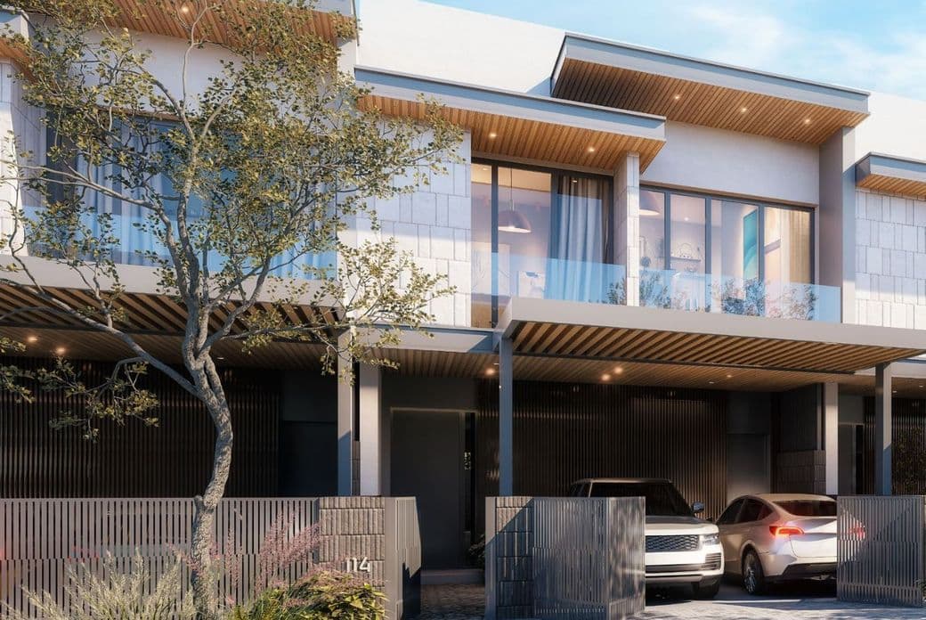 Close-up view of a contemporary 3-bedroom Pinewood Estate Home façade with two-car garage, vertical slat fencing, wood-accented soffits, and floor-to-ceiling windows.