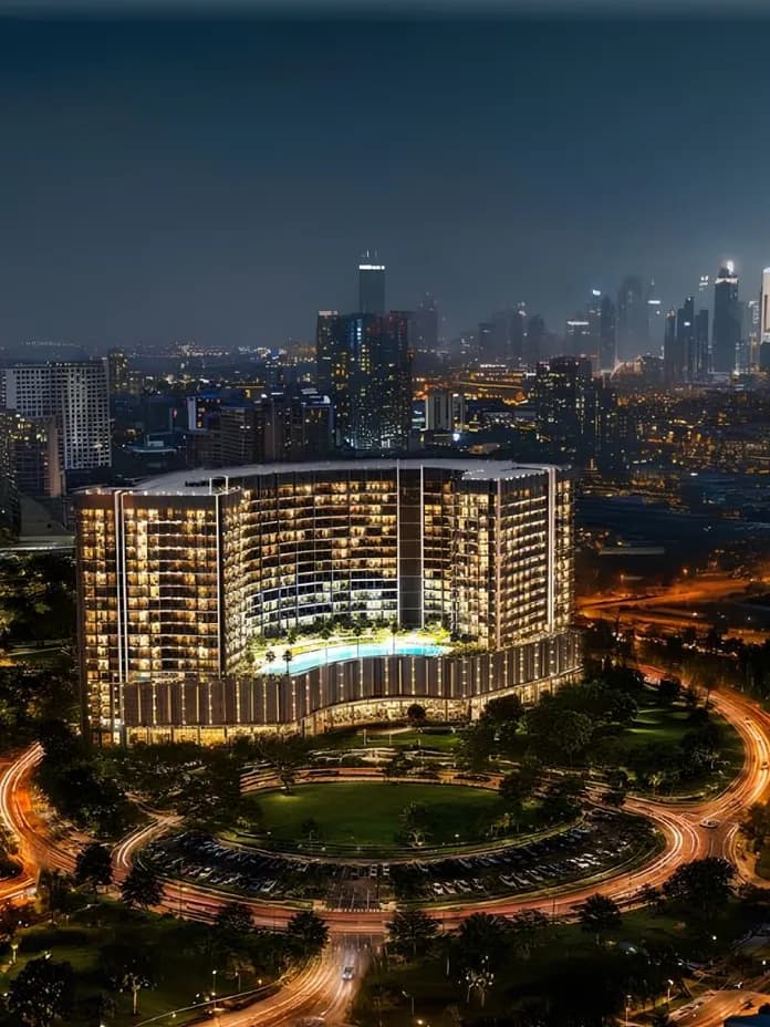 Nighttime cityscape featuring a curved glass hotel with a pool in the foreground, surrounding light-trail roads and a distant skyline of skyscrapers. AI-generated image