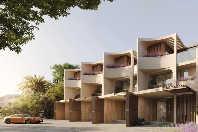 Modern row of luxury townhouses with curved facades, balconies, and a parked car and motorcycle, surrounded by trees under a clear sky.