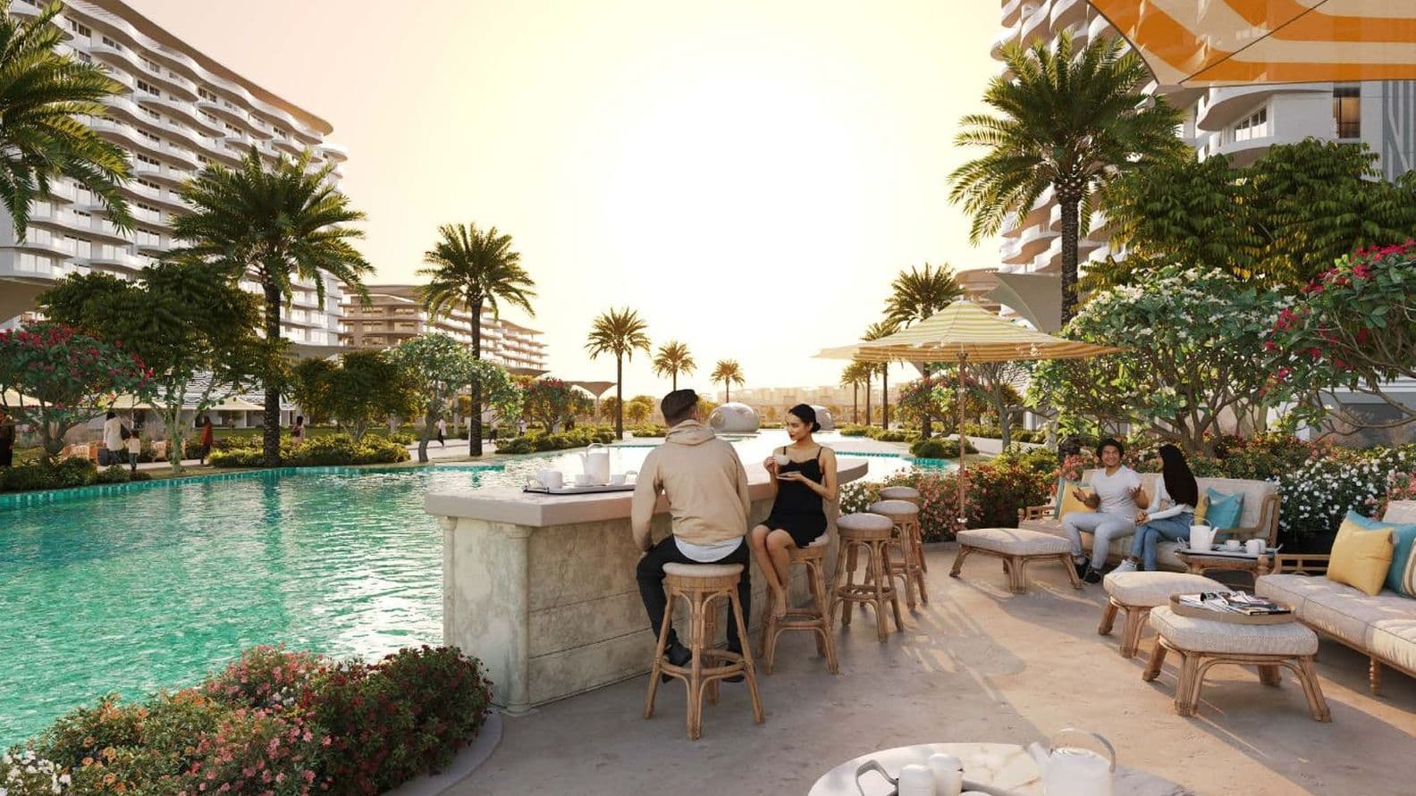 People relaxing by a poolside bar at a luxurious resort with palm trees and modern buildings in the background, during sunset.