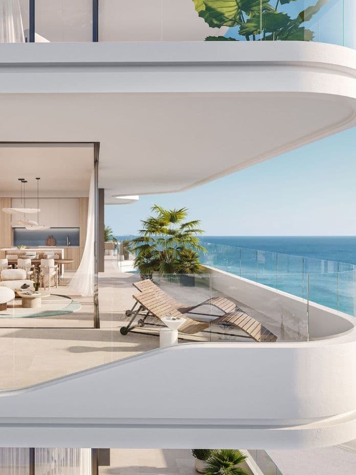 Expansive balcony with sea view at Nikki Beach Residences by Aldar in RAK, showcasing elegant outdoor lounge and dining space.