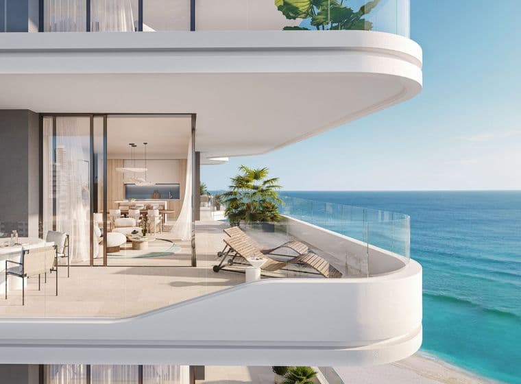 Expansive balcony with sea view at Nikki Beach Residences by Aldar in RAK, showcasing elegant outdoor lounge and dining space.