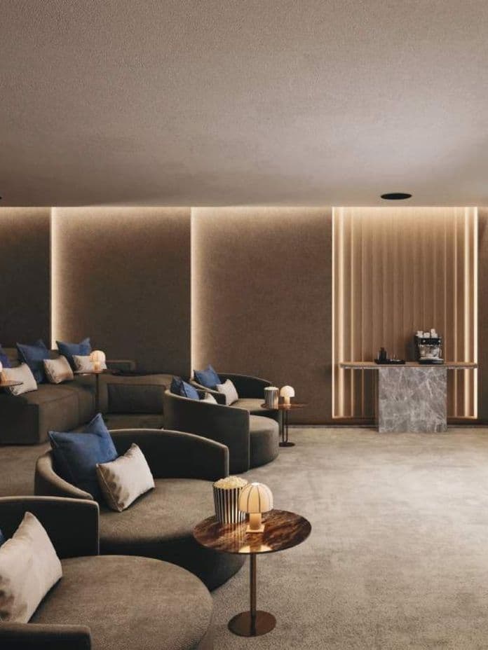 Private home cinema with plush armchairs and ambient lighting at Residences Du Port.