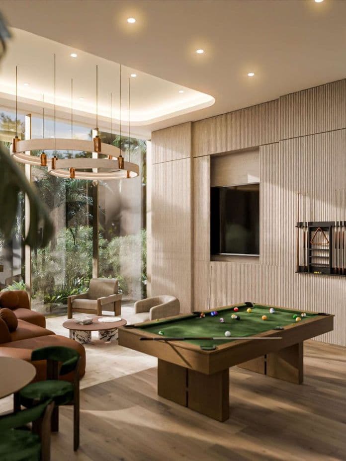 Sophisticated games and lounge room featuring a central pool table, plush seating, natural wood finishes, and large windows with garden views.