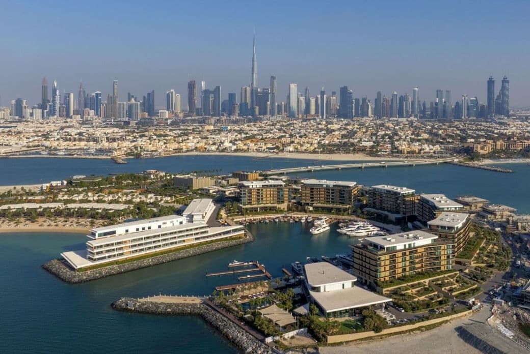 ariel view of jumeirah bay island with dubai skyline