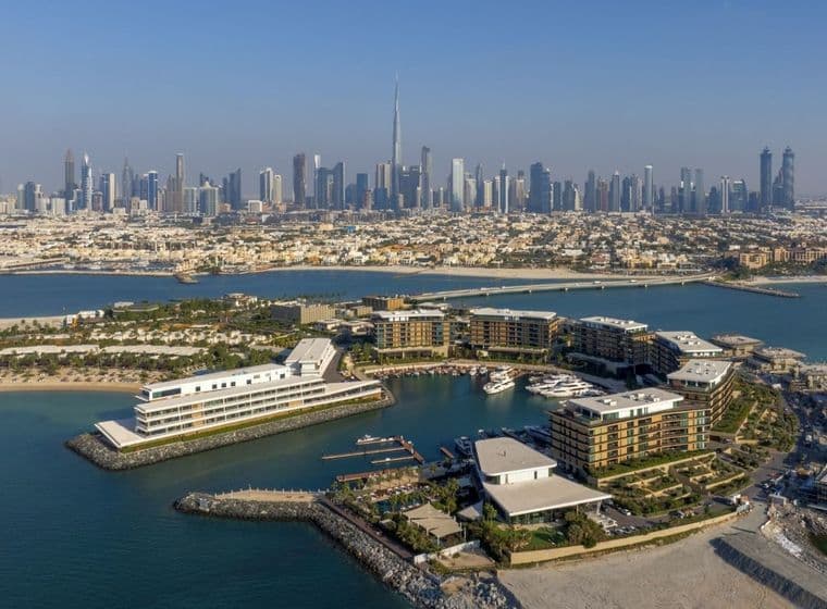 ariel view of jumeirah bay island with dubai skyline