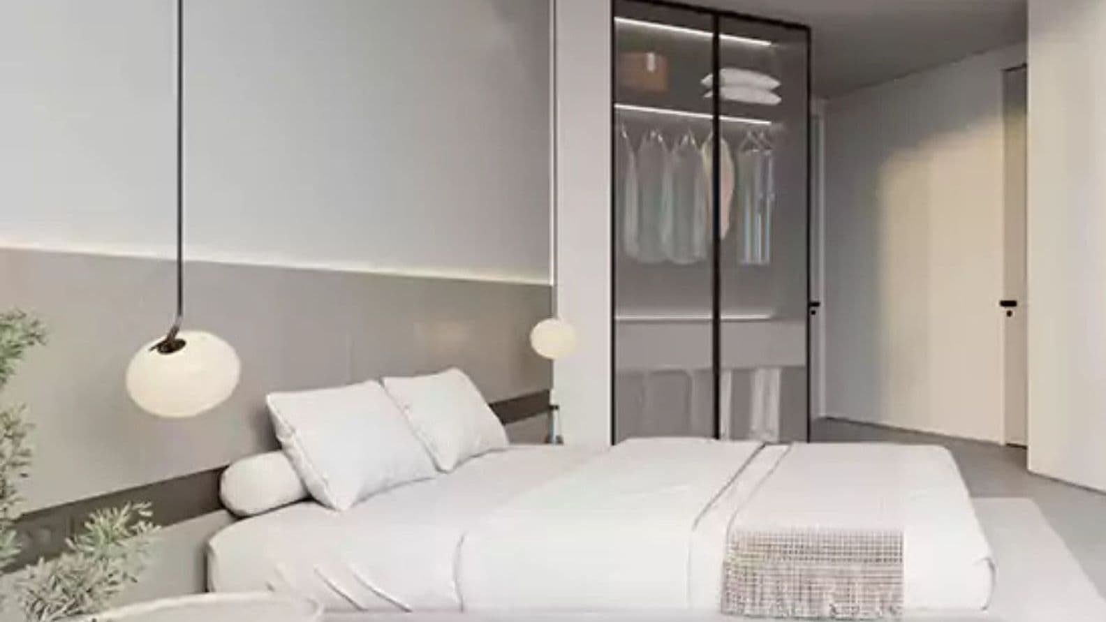 Modernes, minimalistisches Schlafzimmer mit einem Kleiderschrank mit Glasfront und stilvoller Pendelbeleuchtung.