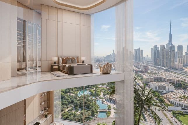 Luxurious hotel suite on a curved glass balcony overlooks the Dubai skyline; plush bed, sheer curtains, and marble floors.