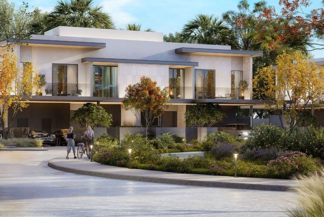 Modern twin villa units at Pinewood Estate Homes surrounded by landscaped greenery, showcasing clean architectural lines and natural tones with large glass windows and shaded terraces.