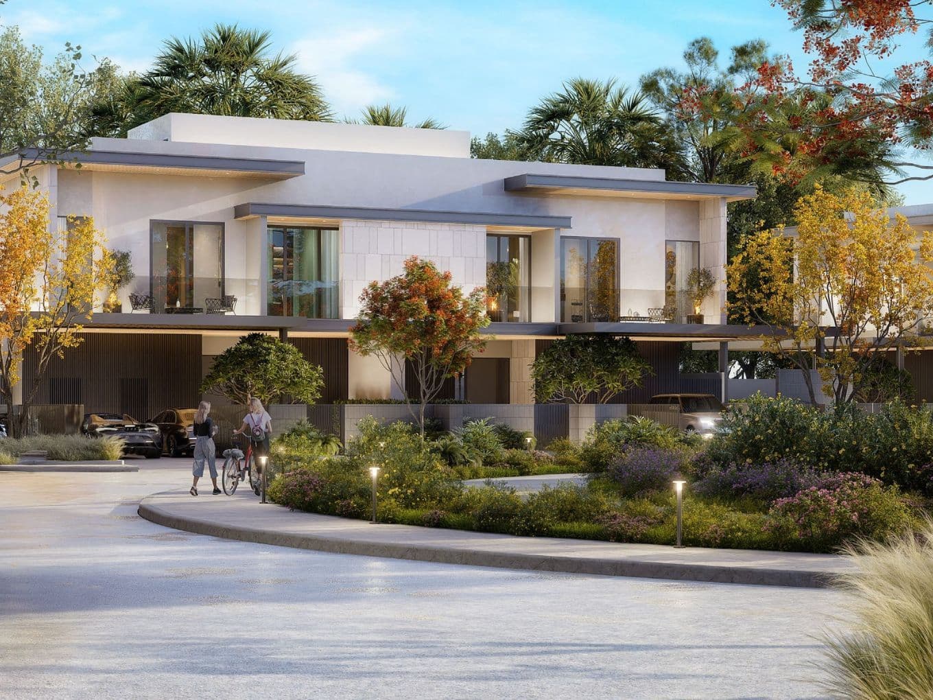 Modern twin villa units at Pinewood Estate Homes surrounded by landscaped greenery, showcasing clean architectural lines and natural tones with large glass windows and shaded terraces.