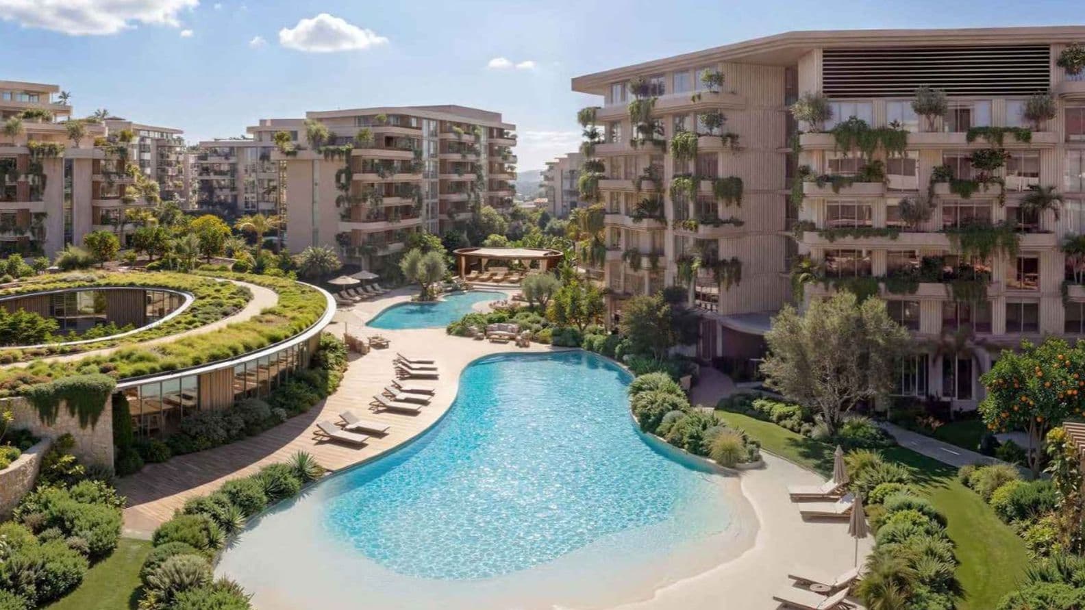 Modern apartment complex with lagoon-style pool, sandy beach edge, lounge chairs and lush landscaping