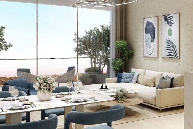 Modern living-dining area with light beige sofa, blue chairs, elegant dining table, abstract art, and greenery by large windows.