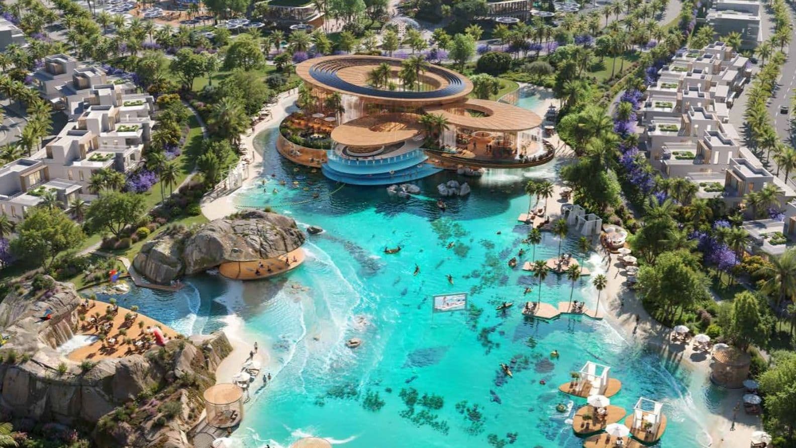 Aerial view of a luxury resort with villas, a turquoise pool, palm trees, and various recreational areas, surrounded by greenery and parking.