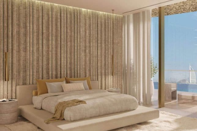 Luxurious bedroom with a modern bed, textured accent wall, floor-to-ceiling windows, and a view of a pool and cityscape.