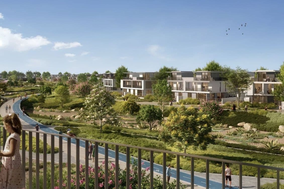 View from a villa balcony overlooking a landscaped jogging and cycling track surrounded by lush gardens, trees, and modern townhouses in The Valley.