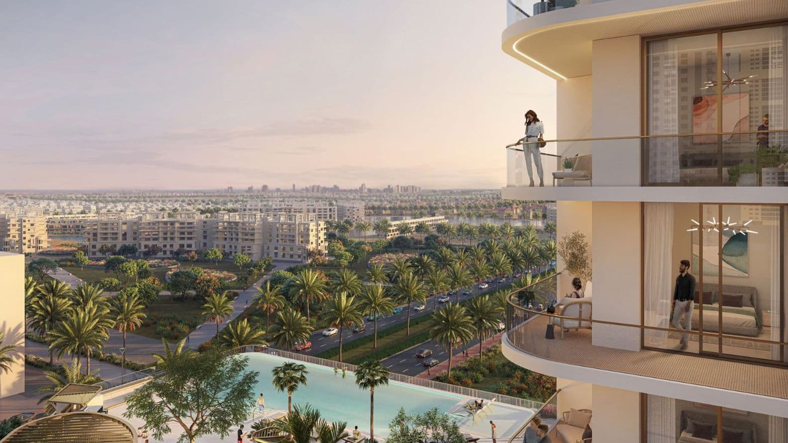 Balcony view from Marriott Residences JLT, showing a woman overlooking the landscaped pool area, palm-lined streets, and modern residential community at sunset.